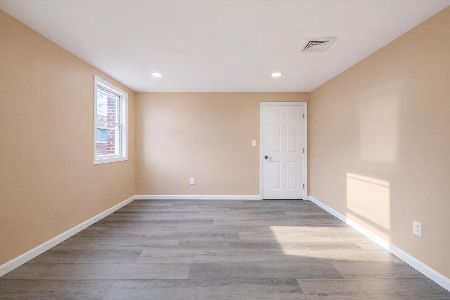 1572 Summit Avenue, Unit 2 Hillside, NJ 07205 - Photo 17 of 20 a view of an empty room with wooden floor and a window