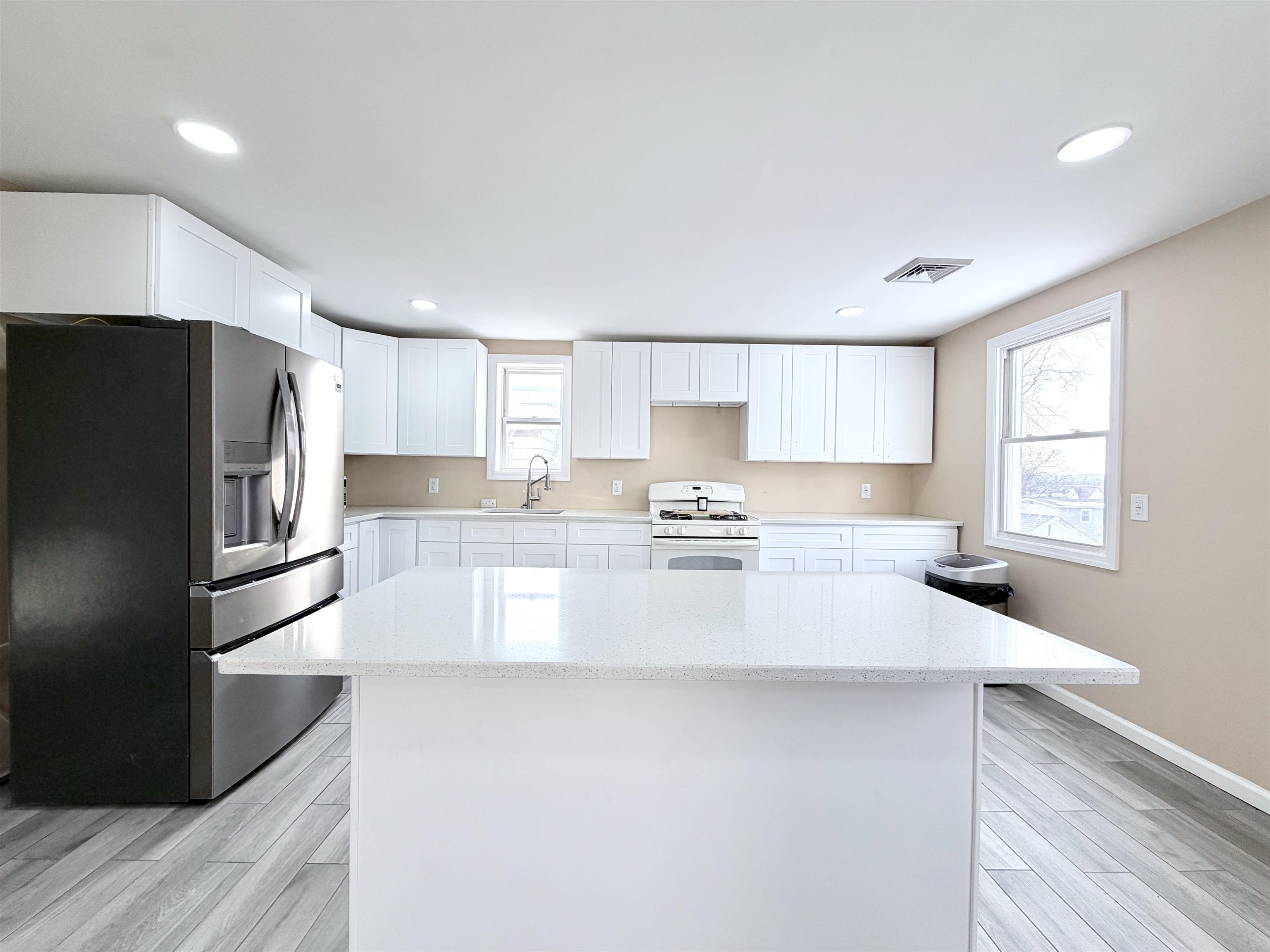 1572 Summit Avenue, Unit 2 Hillside, NJ 07205 - Photo 2 of 20 a kitchen with stainless steel appliances a refrigerator sink and cabinets