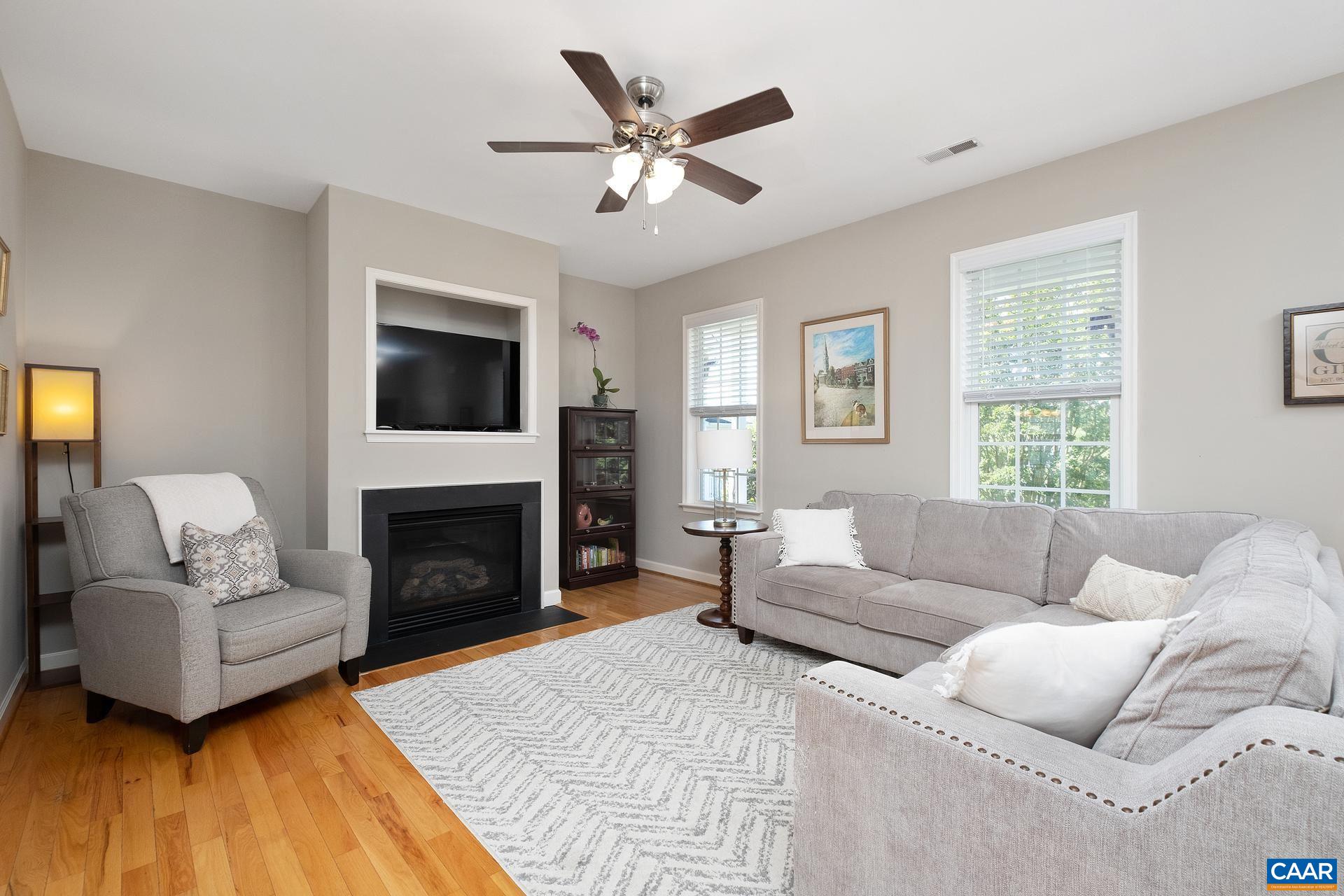 1285 Amber Ridge Road Crozet, VA 22901 - Photo 6 of 33 a living room with furniture a fireplace and a flat screen tv