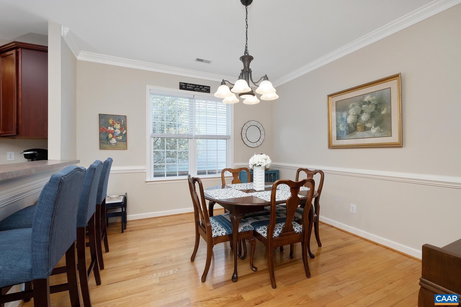 1285 Amber Ridge Road Crozet, VA 22901 - Photo 8 of 33 a view of a dining room with furniture a chandelier and wooden floor