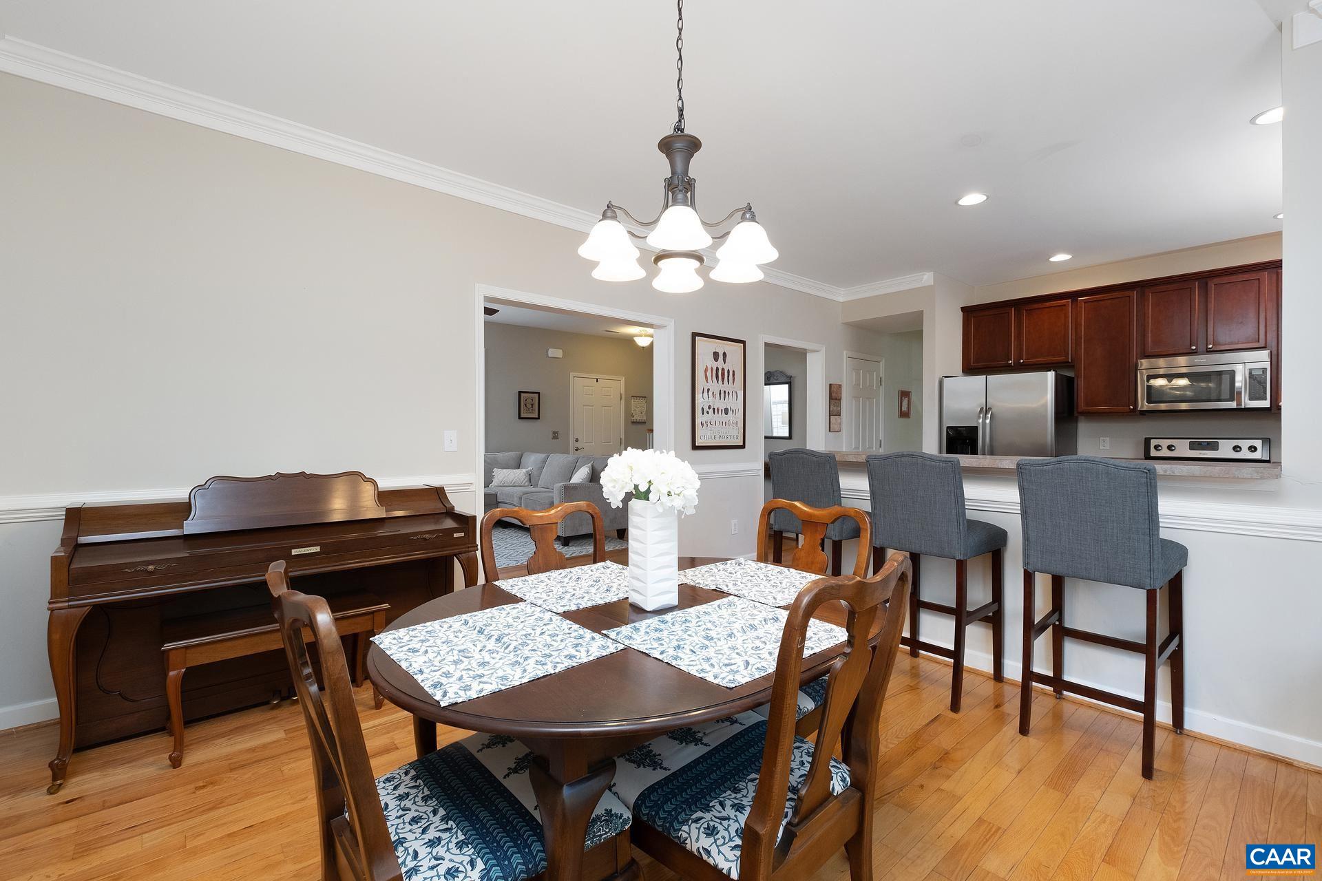 1285 Amber Ridge Road Crozet, VA 22901 - Photo 10 of 33 a view of a dining room with furniture and wooden floor