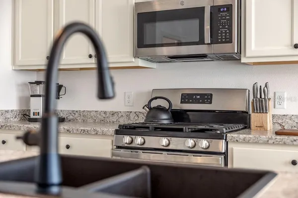 a kitchen with a stove and a microwave