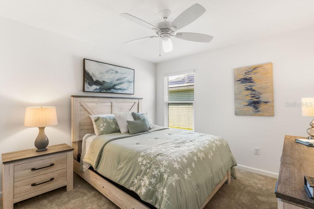 2938 Chimborazo Way The Villages, FL 32163 - Photo 17 of 50 a bedroom with a bed and a chandelier