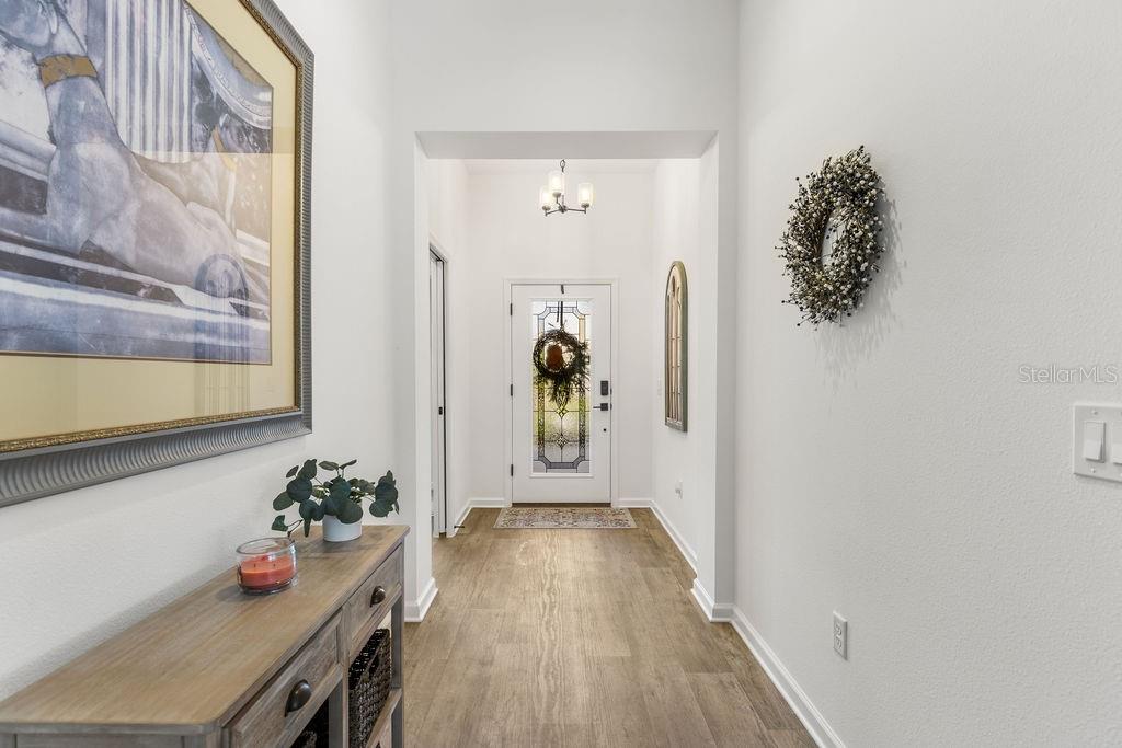 2938 Chimborazo Way The Villages, FL 32163 - Photo 18 of 50 a hallway with front door wooden floor and windows