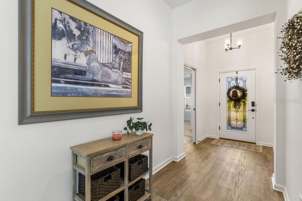 2938 Chimborazo Way The Villages, FL 32163 - Photo 19 of 50 a view of a hallway with entryway and wooden floor