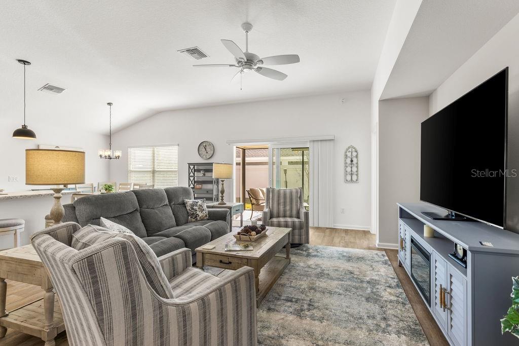 2938 Chimborazo Way The Villages, FL 32163 - Photo 2 of 50 a living room with furniture and a flat screen tv