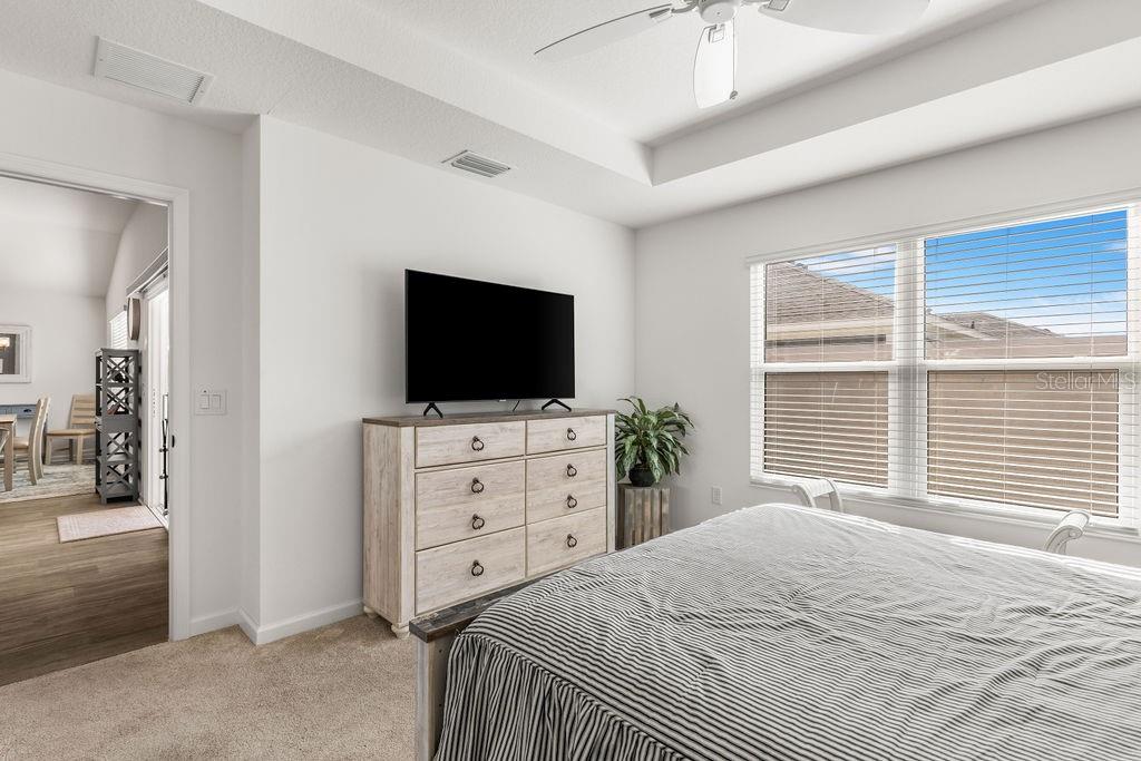 2938 Chimborazo Way The Villages, FL 32163 - Photo 23 of 50 a bedroom with a bed and a flat screen tv