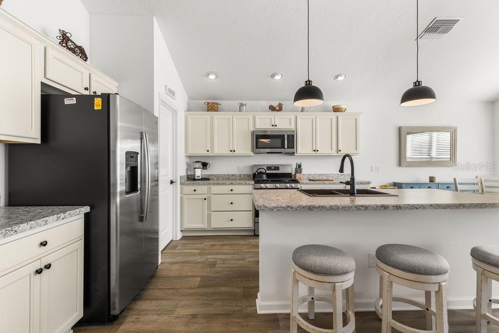 2938 Chimborazo Way The Villages, FL 32163 - Photo 30 of 50 a kitchen with stainless steel appliances a sink stove and refrigerator