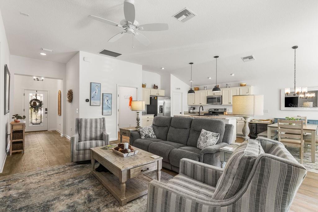 2938 Chimborazo Way The Villages, FL 32163 - Photo 3 of 50 a living room with furniture kitchen view and a chandelier