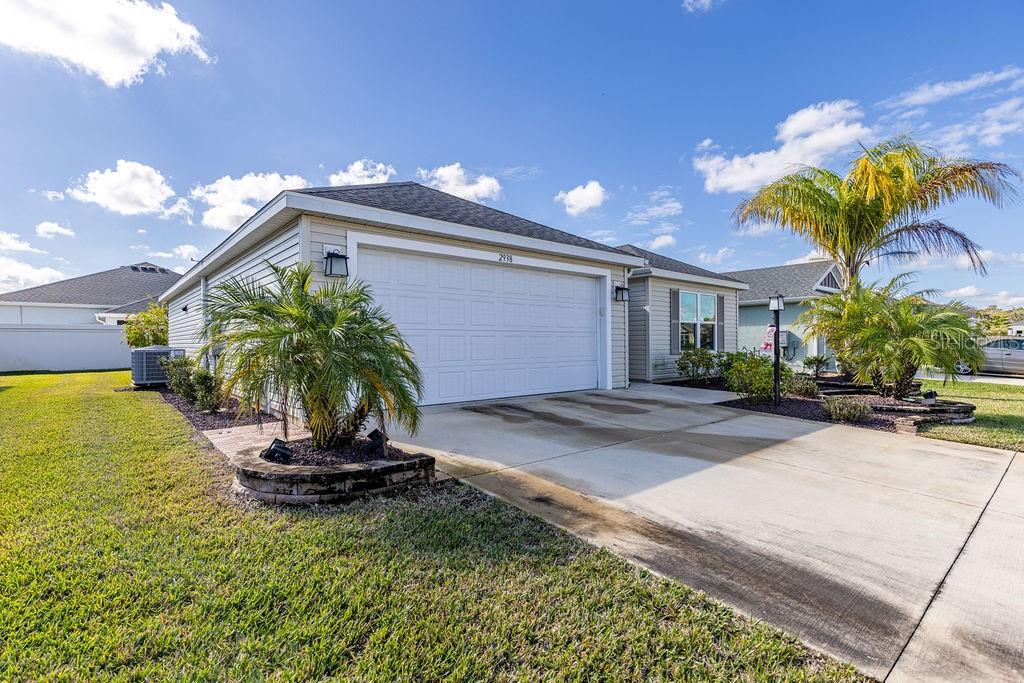 2938 Chimborazo Way The Villages, FL 32163 - Photo 7 of 50 a view of a house with a yard and potted plants