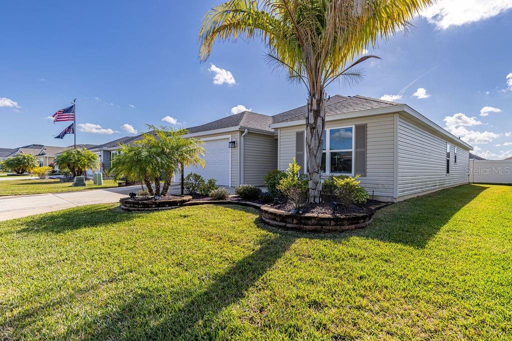 2938 Chimborazo Way The Villages, FL 32163 - Photo 9 of 50 a front view of a house with swimming pool having outdoor seating