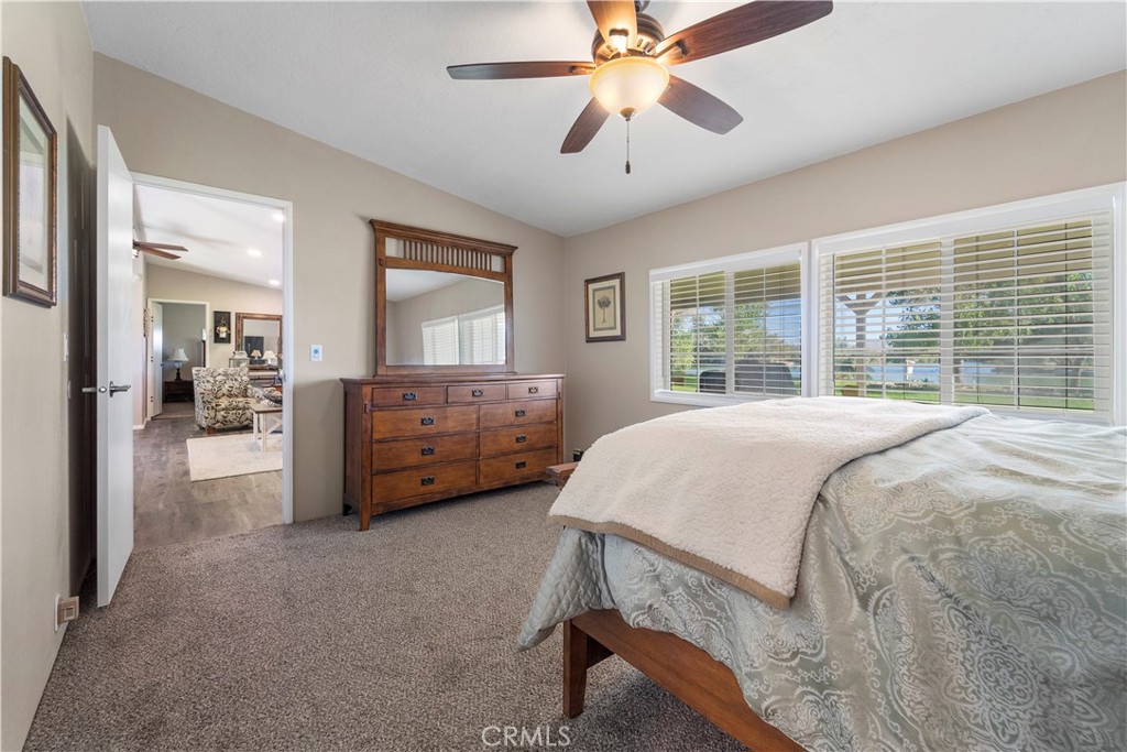 48197 Valley Center Road Newberry Springs, CA 92365 - Photo 20 of 30 a bedroom with a large bed and a chandelier
