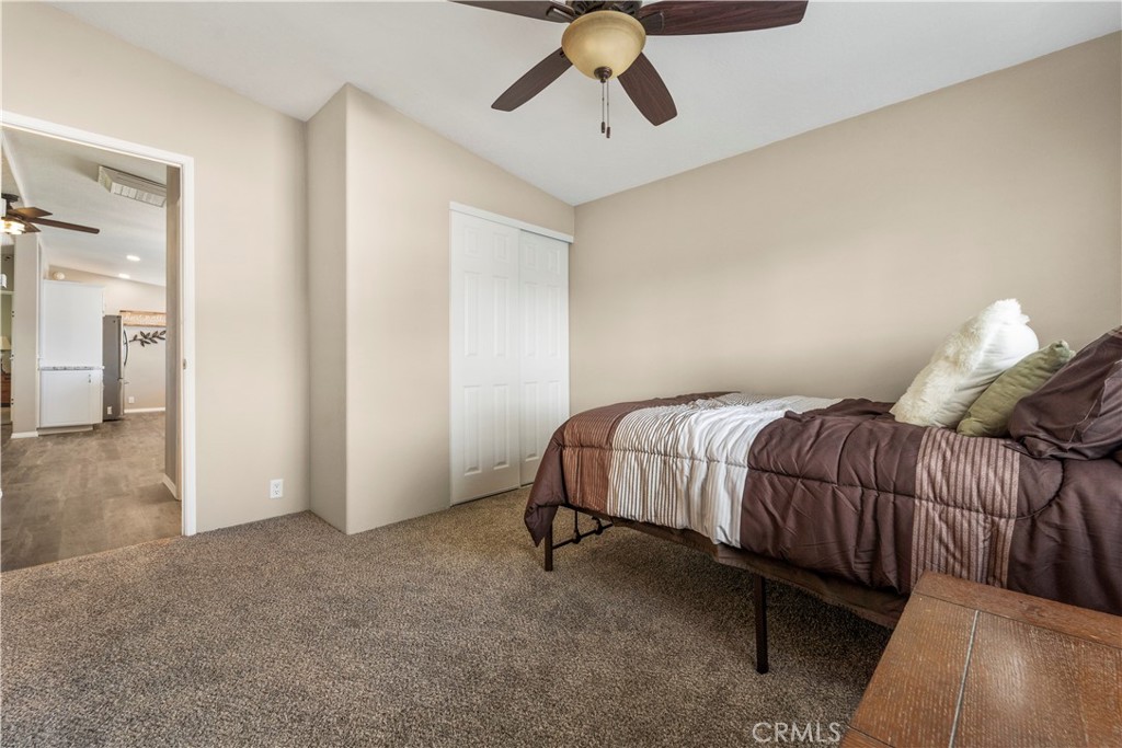 48197 Valley Center Road Newberry Springs, CA 92365 - Photo 24 of 30 a bedroom with a bed and wooden floor