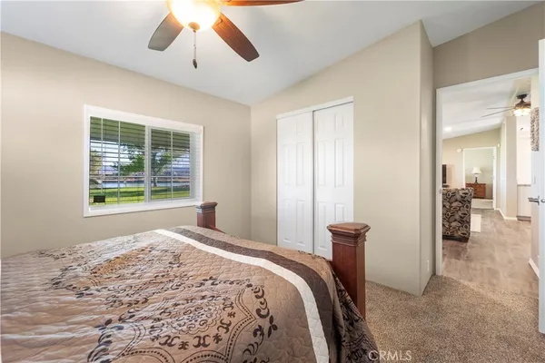 a bedroom with a bed and a large window