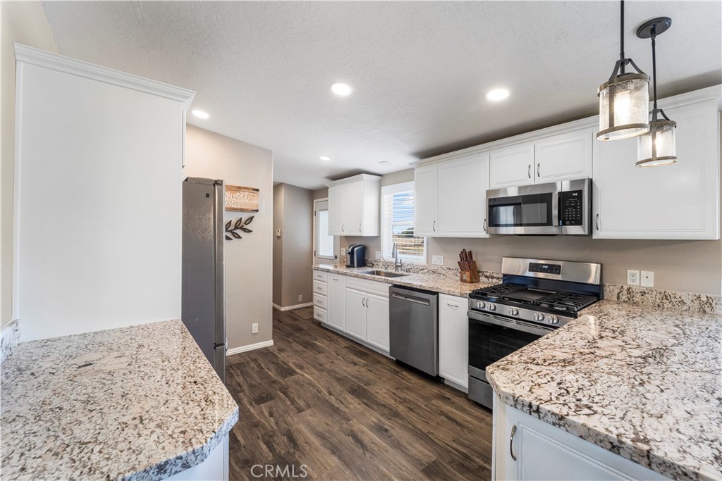 48197 Valley Center Road Newberry Springs, CA 92365 - Photo 6 of 30 a kitchen with a sink stove and refrigerator