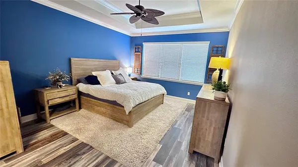 a bedroom with furniture and a chandelier