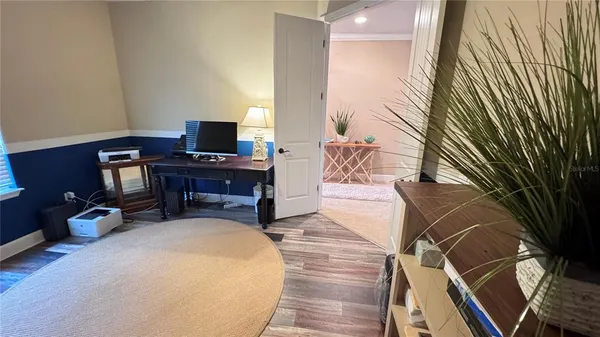 a view of a room with furniture and chandelier