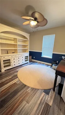 a view of a hallway with livingroom and stairs