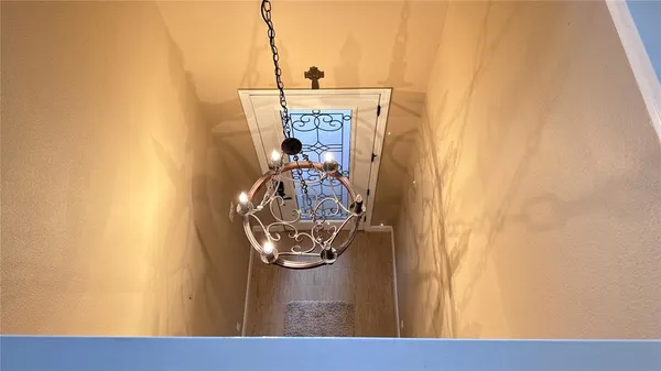 a spacious bedroom with a bed and a chandelier