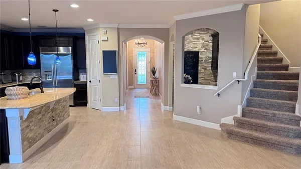 a view of a hallway with wooden floor and a bathroom