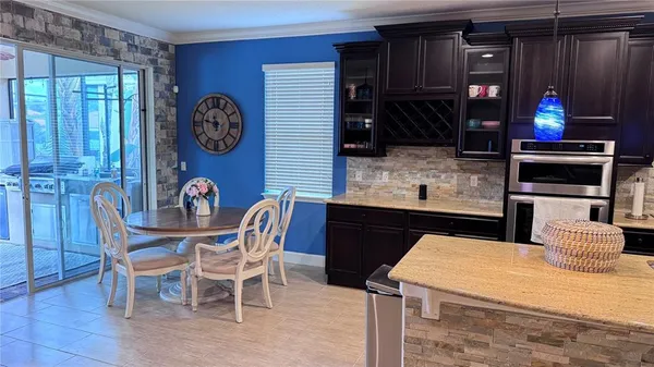 a kitchen with a table and chairs