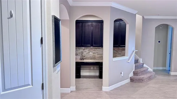 a kitchen with stainless steel appliances a stove a microwave a sink and cabinets