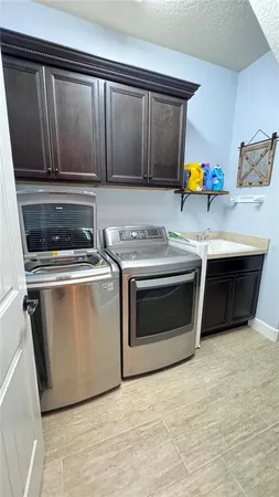 a bathroom with a tub sink and cabinets