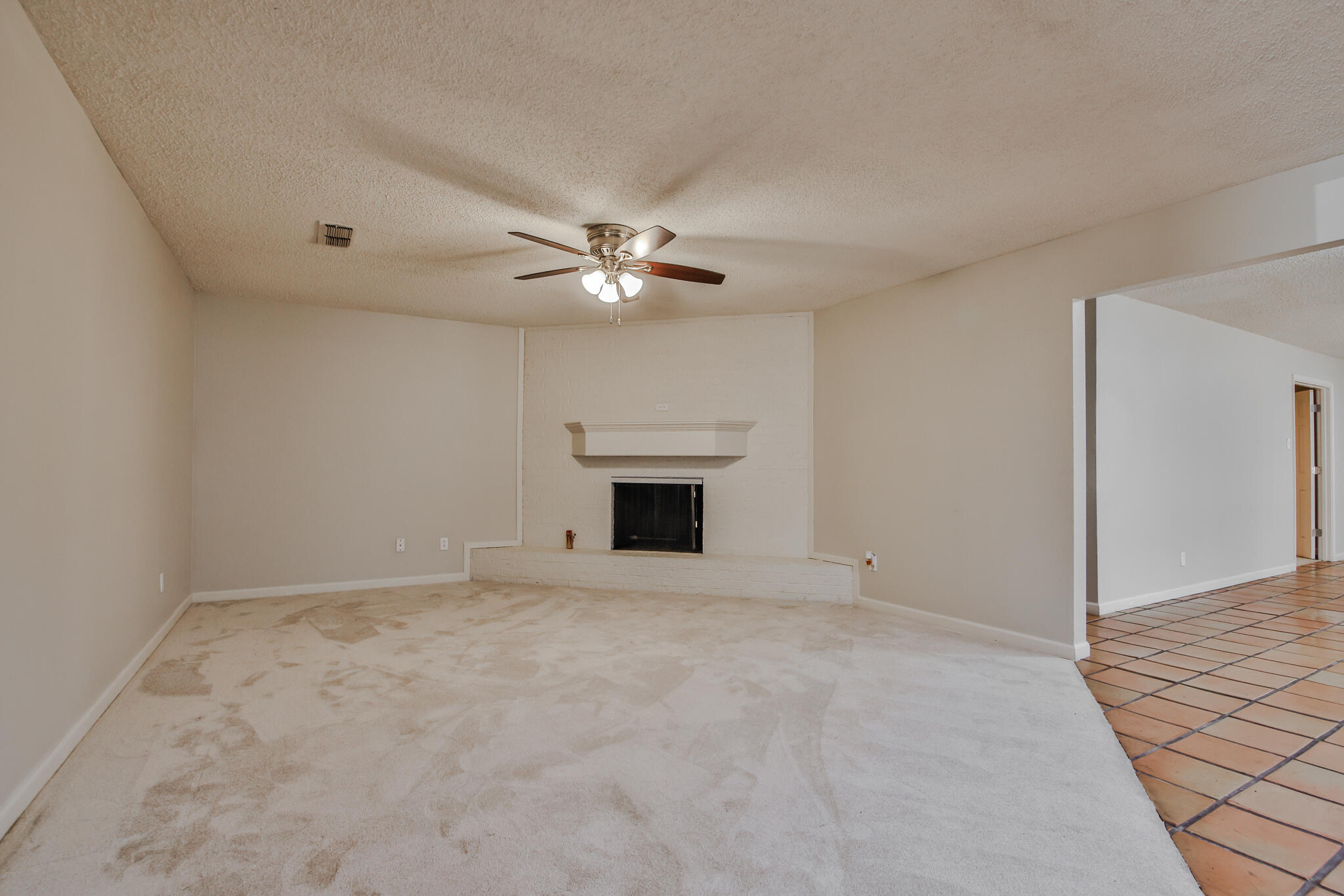 5437 45th Street Lubbock, TX 79414 - Photo 12 of 52 a view of an empty room with a fireplace