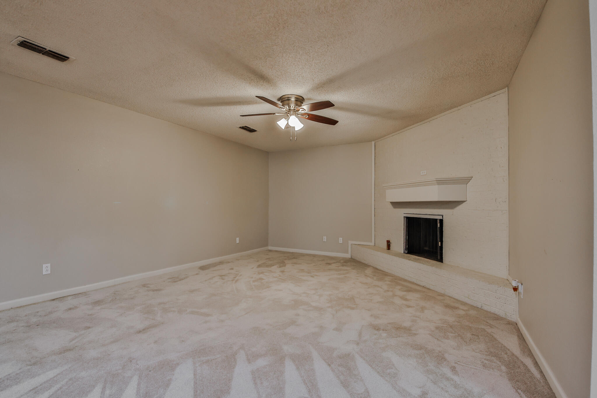 5437 45th Street Lubbock, TX 79414 - Photo 13 of 52 a view of an empty room with a ceiling fan and window