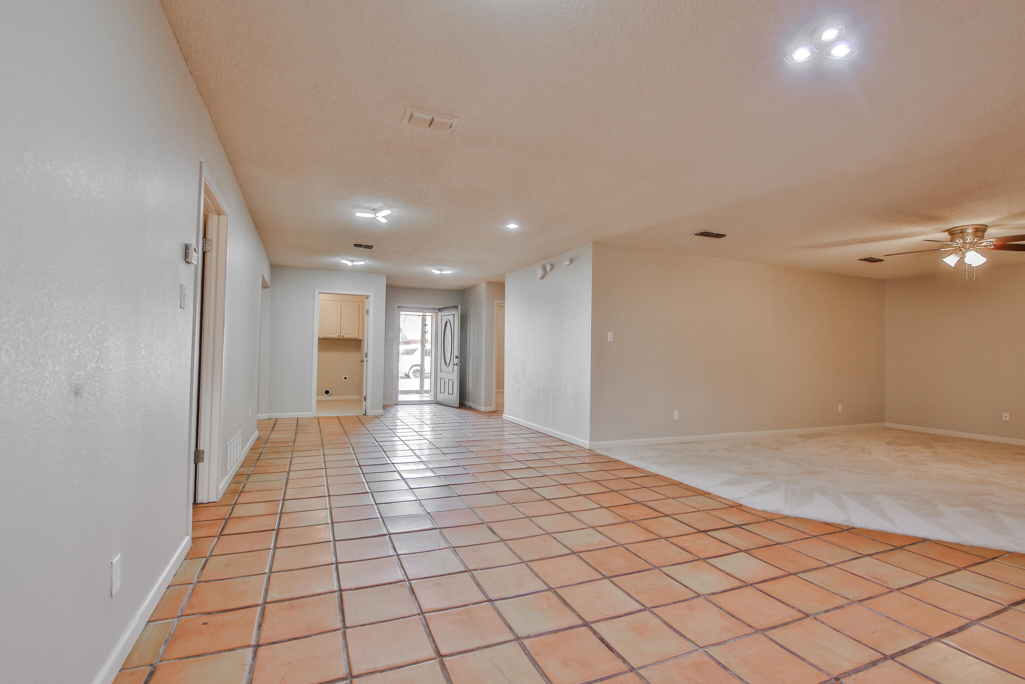 5437 45th Street Lubbock, TX 79414 - Photo 16 of 52 a view of a hallway with wooden floor and a chandelier