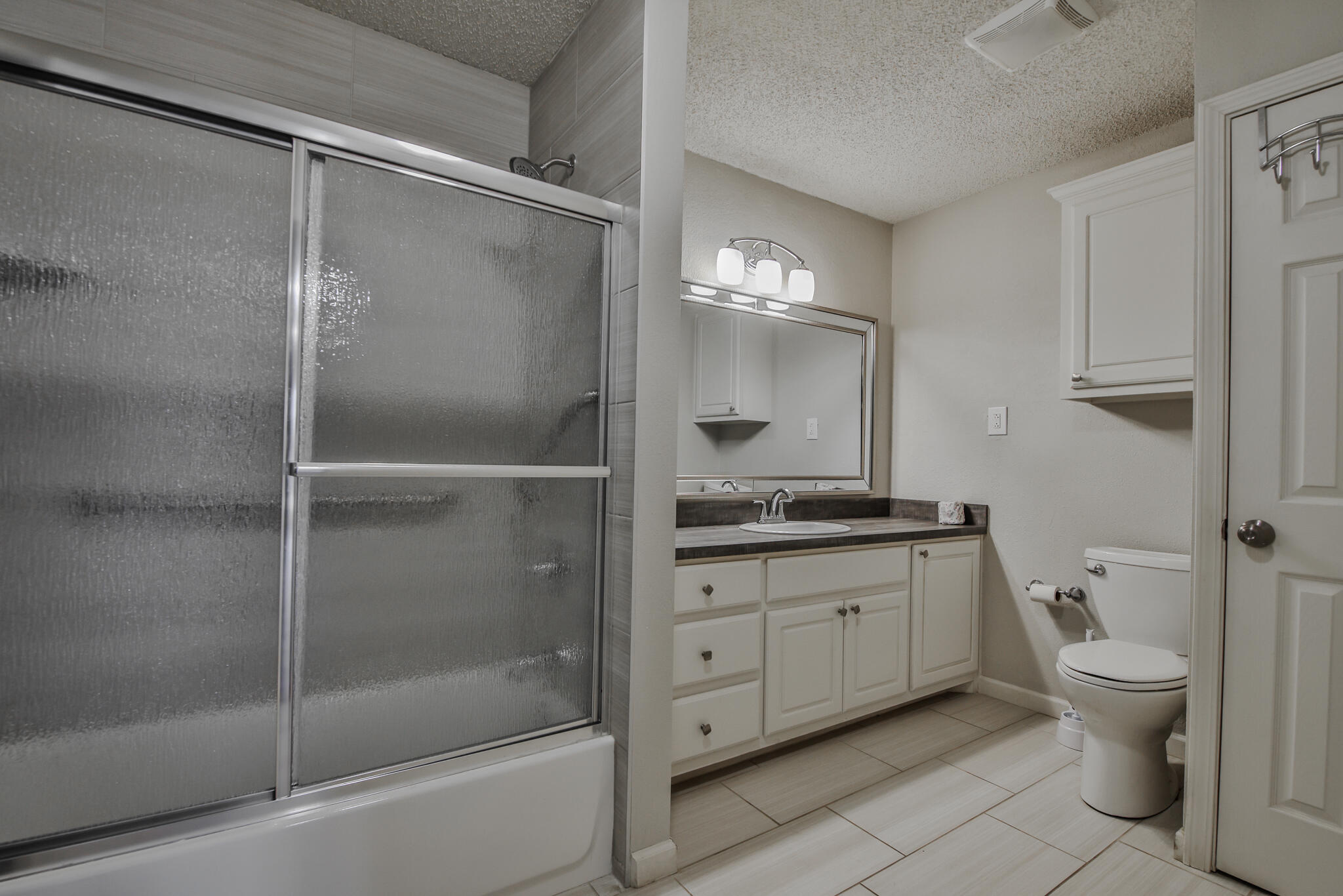 5437 45th Street Lubbock, TX 79414 - Photo 21 of 52 a bathroom with a granite countertop sink toilet and shower