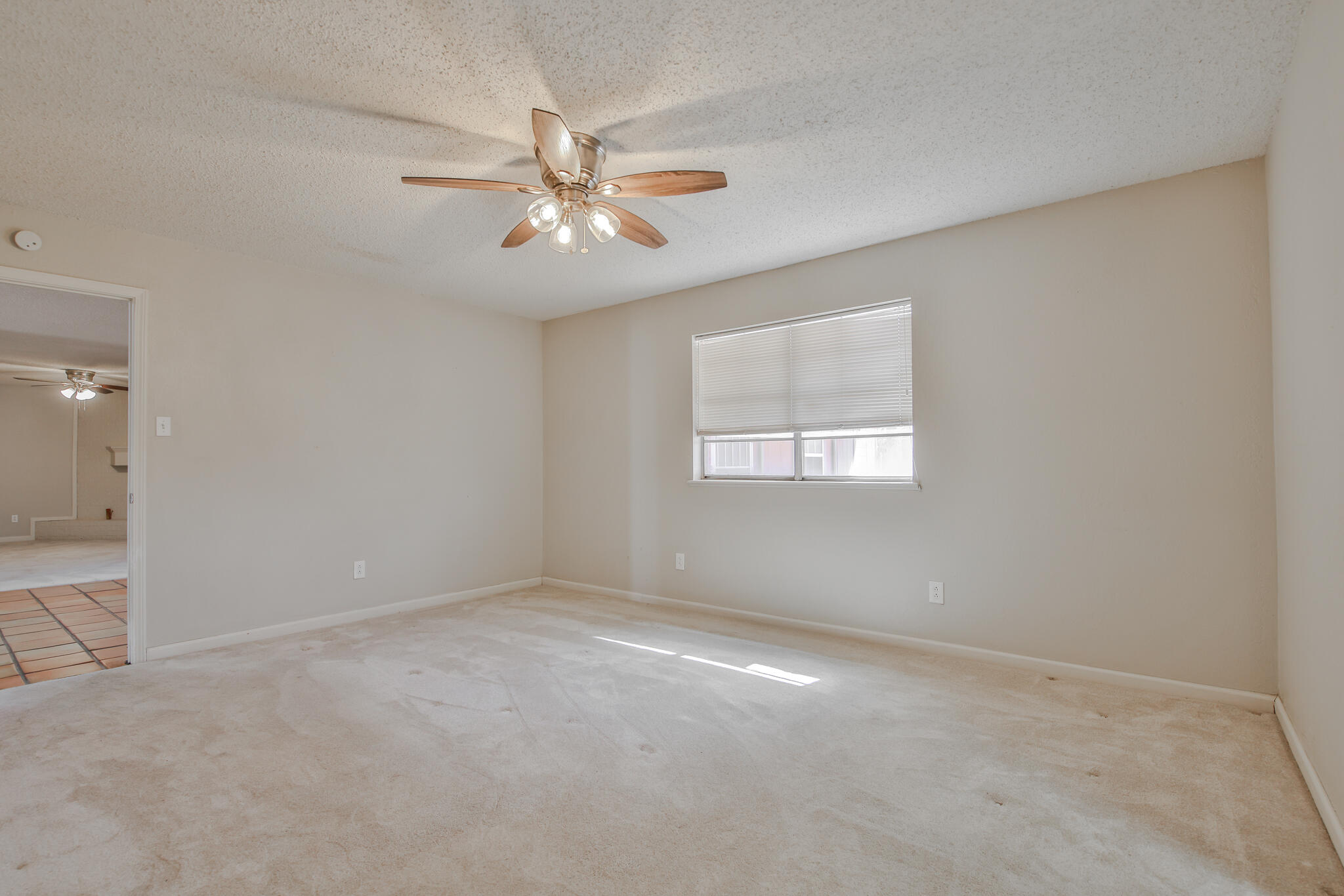 5437 45th Street Lubbock, TX 79414 - Photo 26 of 52 an empty room with windows and fan