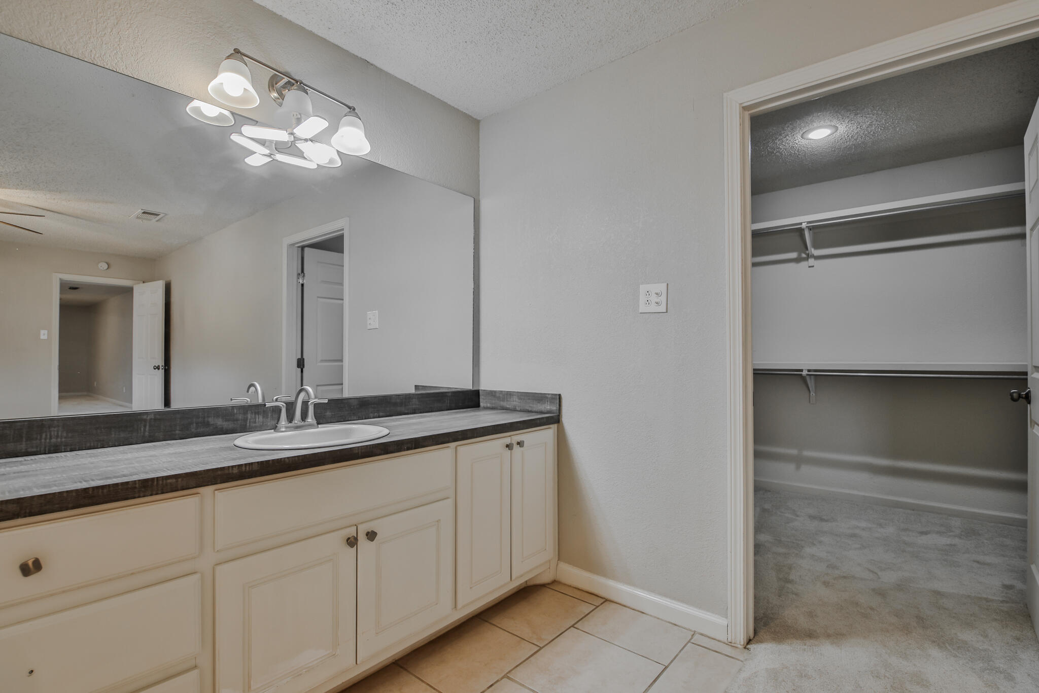 5437 45th Street Lubbock, TX 79414 - Photo 29 of 52 a bathroom with a double vanity sink and a mirror