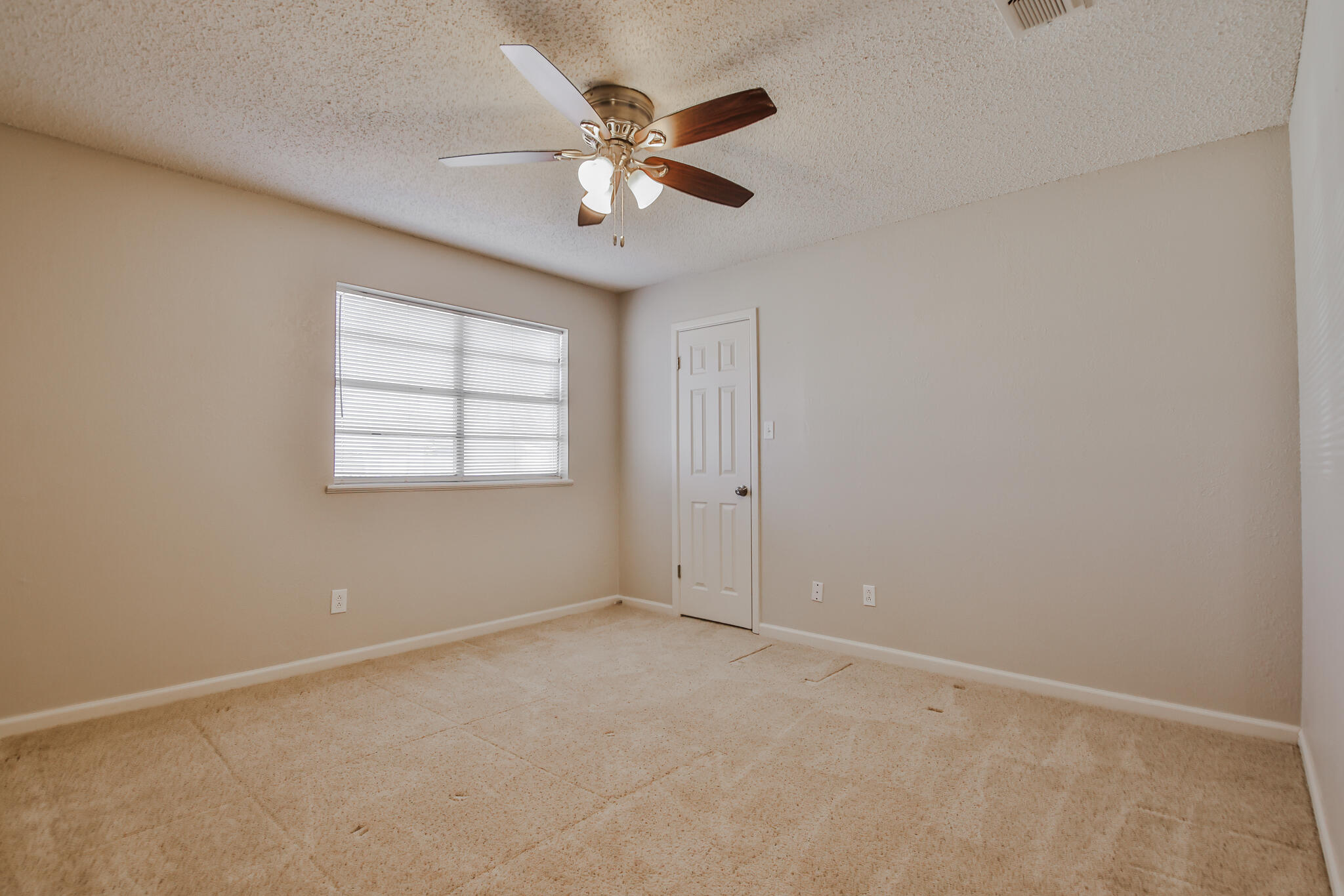 5437 45th Street Lubbock, TX 79414 - Photo 33 of 52 an empty room with windows and fan
