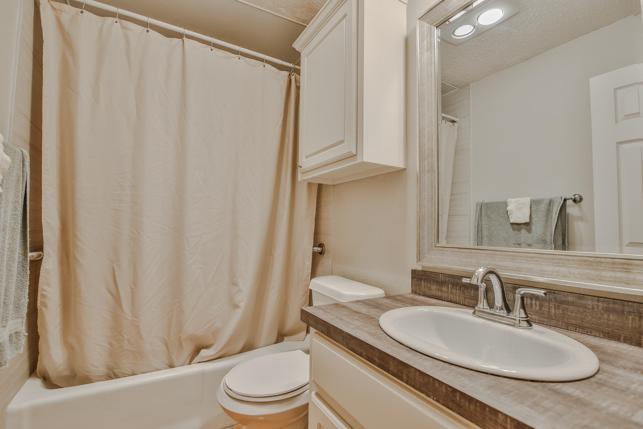 5437 45th Street Lubbock, TX 79414 - Photo 36 of 52 a bathroom with a granite countertop sink toilet and a mirror
