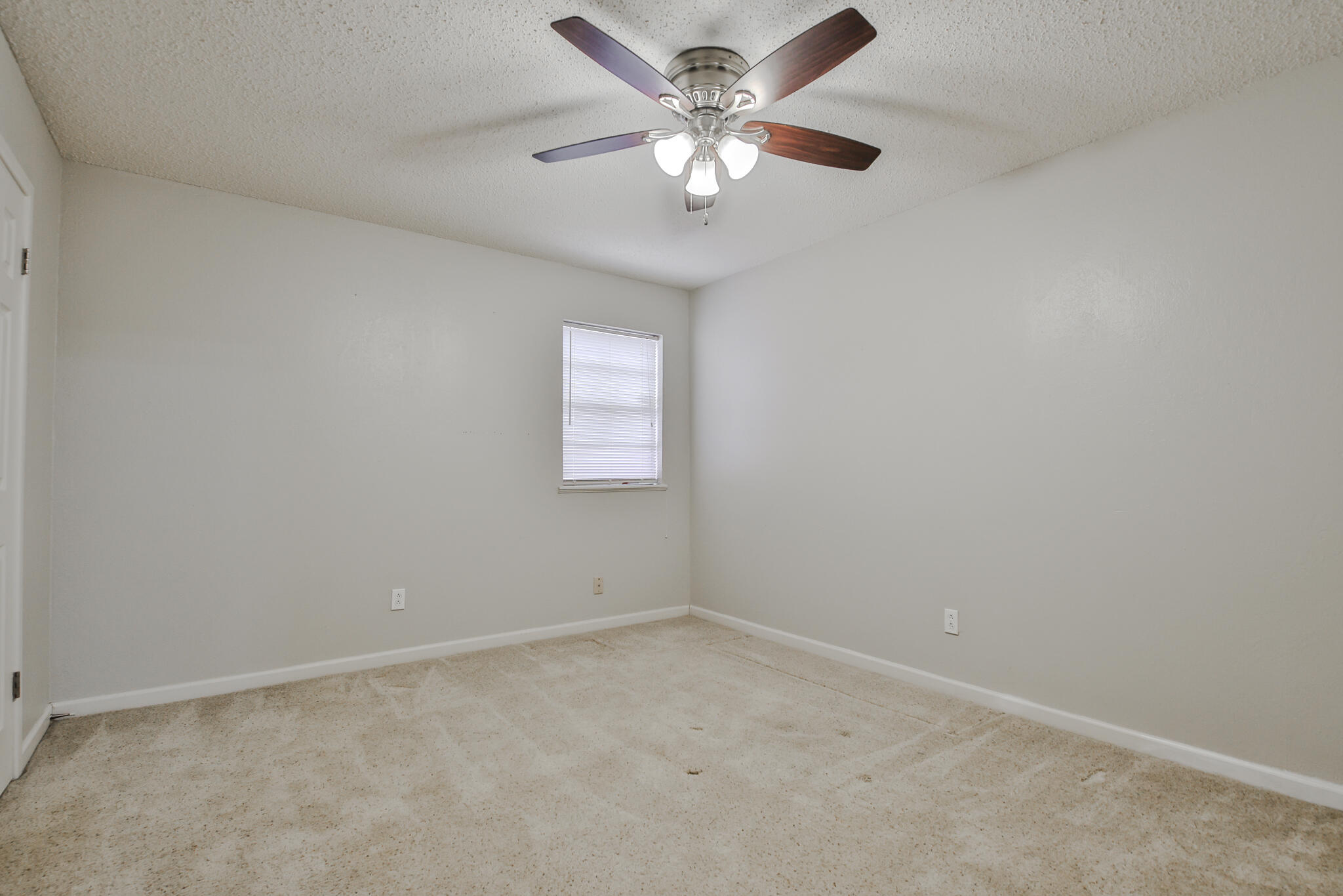 5437 45th Street Lubbock, TX 79414 - Photo 39 of 52 an empty room with a window and a fan