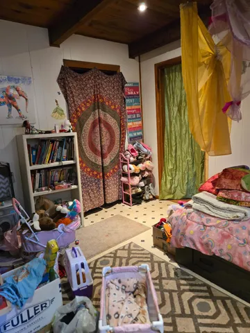 a bed room with a bed and a book shelf