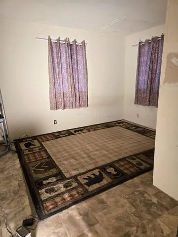 a view of a room with wooden floor and window