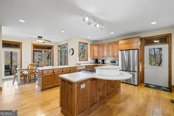 a kitchen with stainless steel appliances granite countertop a sink a stove and a refrigerator