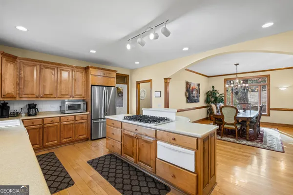 a kitchen with stainless steel appliances granite countertop a sink dishwasher and cabinets with wooden floor