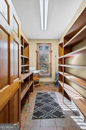 a bedroom with a bed couch and large window