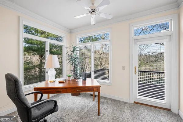 a bathroom with a tub a window and a sink