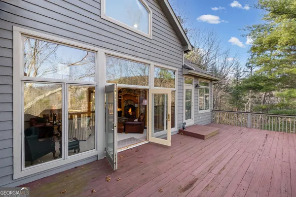 a view of a patio with table and chairs and wooden floor