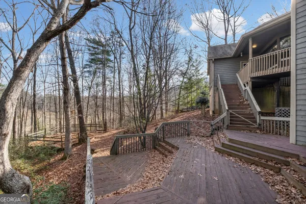 a view of balcony with wooden floor and white walls