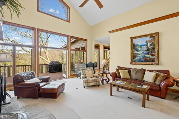a view of a hallway with wooden floor and furniture