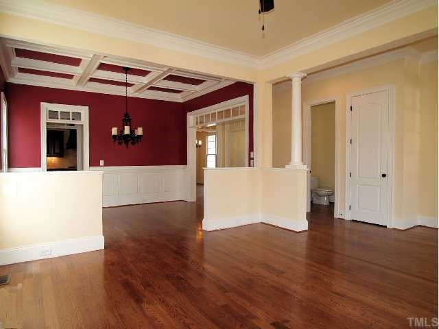 3109 Raymond Street Raleigh, NC 27607 - Photo 4 of 12 Breathtaking formal dining room open to living room boasts decorative columns, coffered ceiling, & beautiful trimwork Dining Room