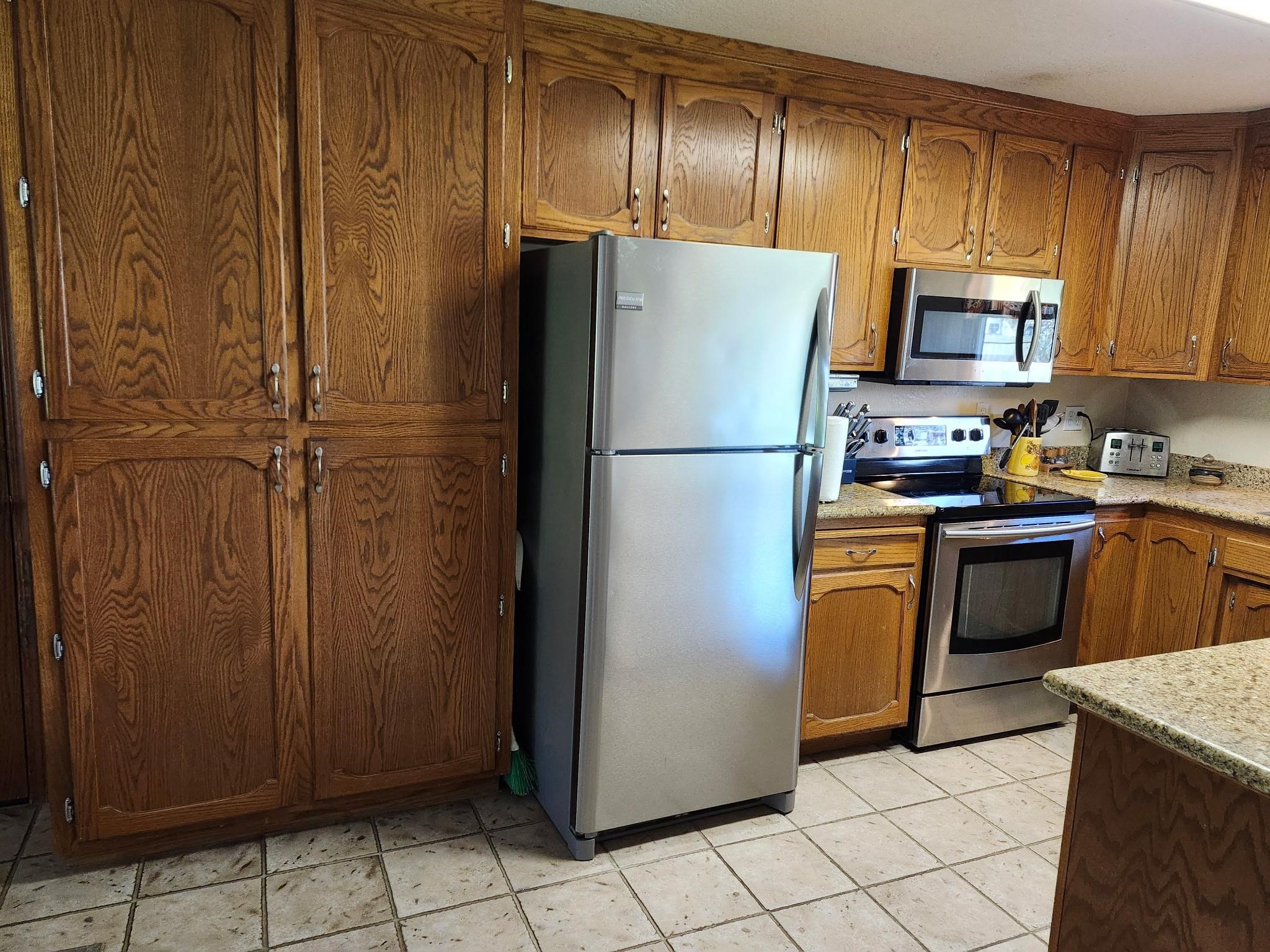 81 Yula Way Oakley, CA 94561 - Photo 31 of 44 a kitchen with cabinets a refrigerator and a stove top oven