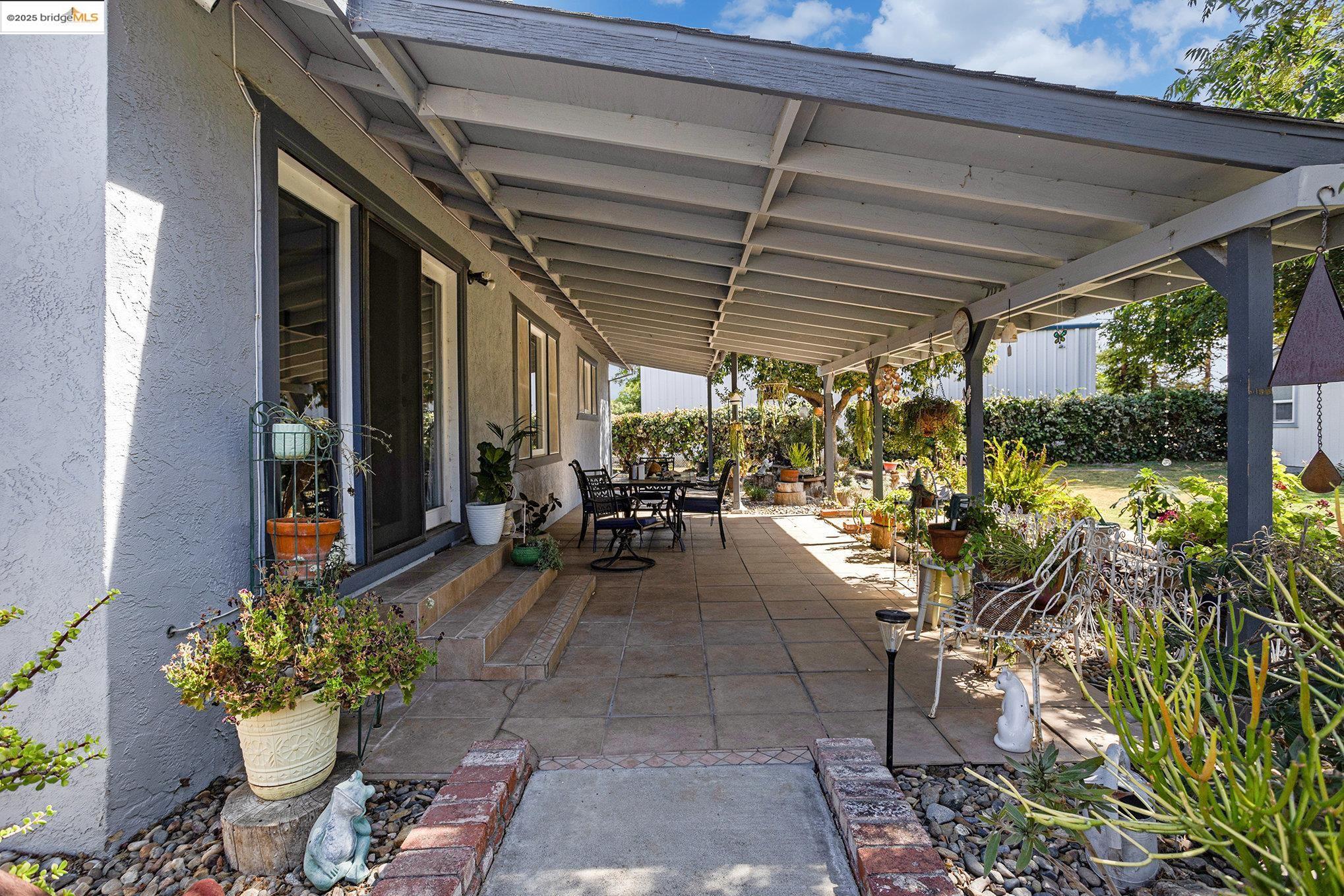 81 Yula Way Oakley, CA 94561 - Photo 8 of 44 a view of a patio with table and chairs potted plants with wooden floor