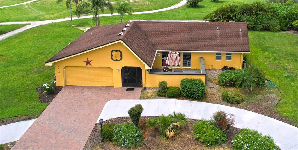 1820 El Rancho Drive Sun City Center, FL 33573 - Photo 2 of 70 a aerial view of a house with a yard
