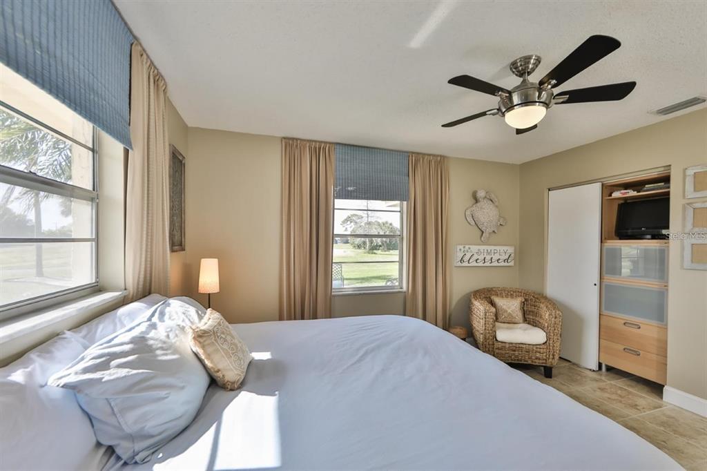 1820 El Rancho Drive Sun City Center, FL 33573 - Photo 27 of 70 a bedroom with a bed and a chandelier